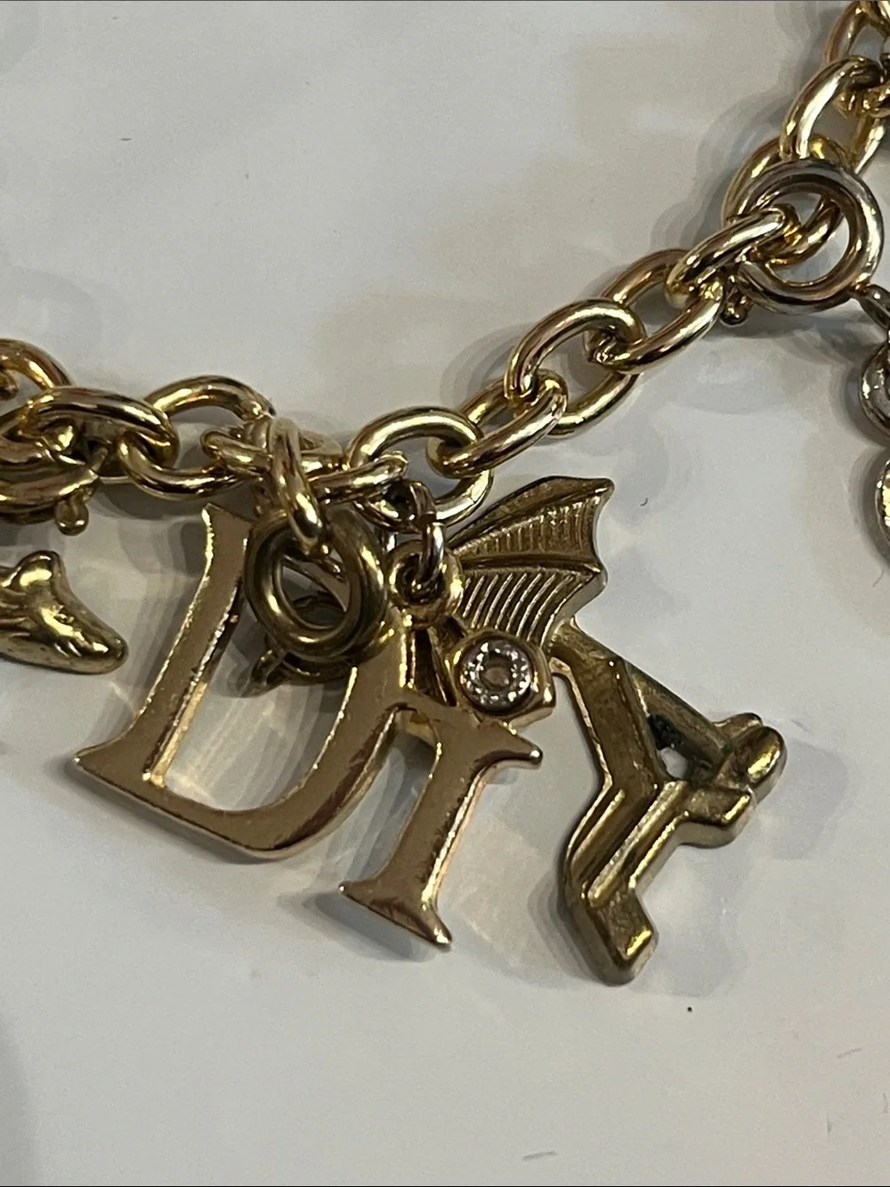 DIAMOND INTERNATIONAL GOLDTONE CHARM BRACELET